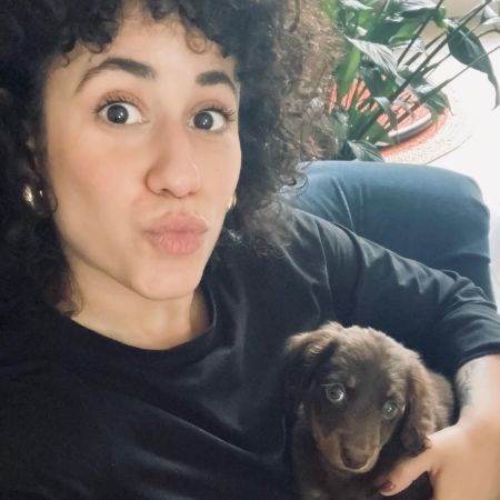 Rachel Mariam is taking a selfie with her dog, Louis.